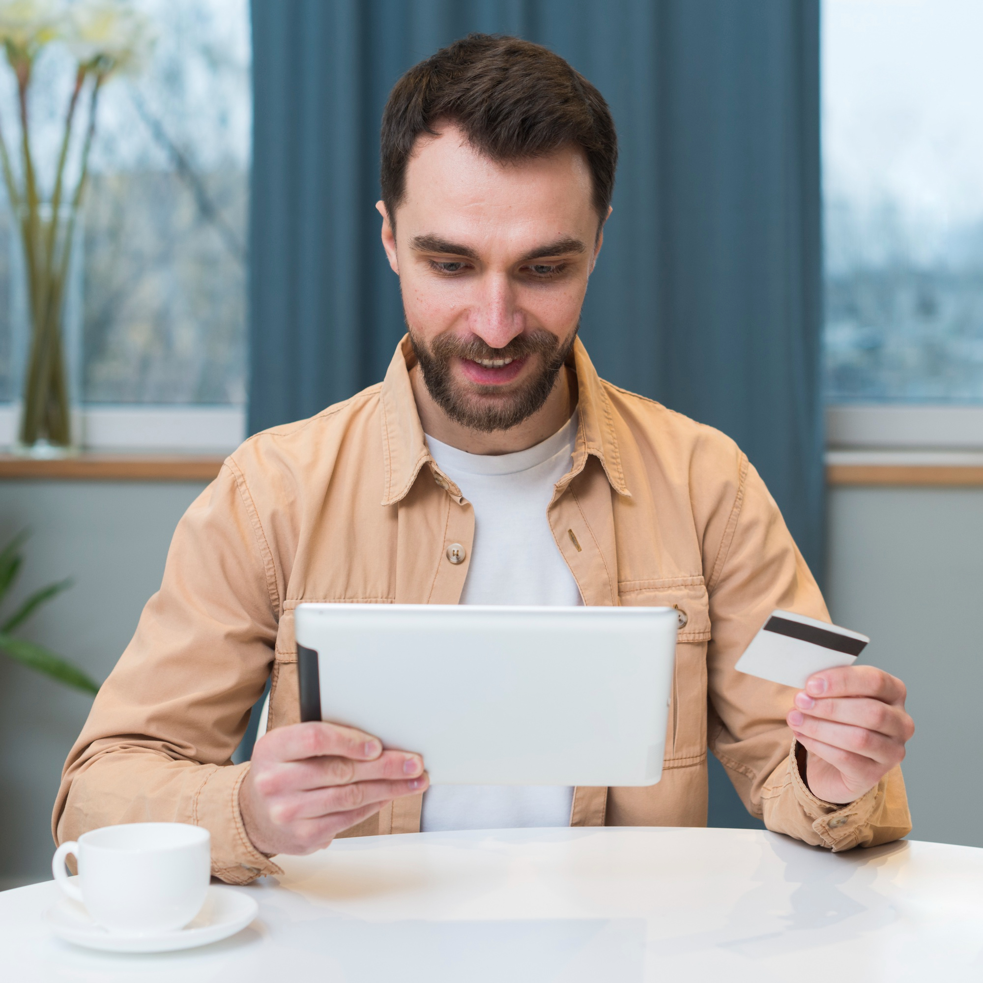 Front view of man shopping online using tablet Front view of man shopping online using tablet
